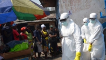 أطباء تابعون للهلال الأحمر الدولي يحملون جثمان شخص توفي في ليبيريا يوم 5 يناير 2017 إثر إصابته بالإيبولا.